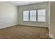 Neutral bedroom with three windows offering natural light at 1019 Dunhill Ln, Waxhaw, NC 28173