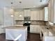 Modern kitchen featuring white cabinets, granite countertops, and stainless steel appliances at 1019 Dunhill Ln, Waxhaw, NC 28173