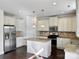 Bright kitchen with stainless steel appliances, granite countertops, tile backsplash, and central island at 1019 Dunhill Ln, Waxhaw, NC 28173