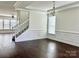 Bright living room featuring dark hardwood floors, white trim, and ample natural light at 1019 Dunhill Ln, Waxhaw, NC 28173