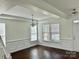 Bright living room featuring dark hardwood floors, white trim, and ample natural light at 1019 Dunhill Ln, Waxhaw, NC 28173
