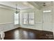 Bright living room featuring dark hardwood floors, white trim, and ample natural light at 1019 Dunhill Ln, Waxhaw, NC 28173