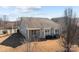 View of the back exterior featuring a cozy covered patio and many windows at 113 Artisan Ct, Mooresville, NC 28117
