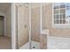 Bathroom featuring a glass door shower with tile surround, and a soaking tub at 113 Artisan Ct, Mooresville, NC 28117