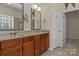 Bathroom with double sinks, wooden cabinets, and a large mirror at 113 Artisan Ct, Mooresville, NC 28117
