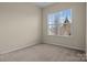 Bedroom featuring neutral carpeting, a light beige color scheme, and one large window at 113 Artisan Ct, Mooresville, NC 28117