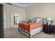 Bedroom with ensuite bathroom access, neutral carpet, and a metal bed frame at 113 Artisan Ct, Mooresville, NC 28117