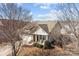 Charming home with a two-car garage, covered porch with rocking chairs, and well-maintained landscaping at 113 Artisan Ct, Mooresville, NC 28117