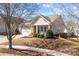 Charming home with a two-car garage, covered porch with rocking chairs, and well-maintained landscaping at 113 Artisan Ct, Mooresville, NC 28117