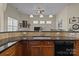Kitchen island with tile backsplash, granite countertops, and a stainless steel sink at 113 Artisan Ct, Mooresville, NC 28117