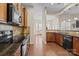 Kitchen with dark wood floors, stainless steel appliances, and an open floor plan at 113 Artisan Ct, Mooresville, NC 28117