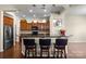 Kitchen with granite countertops, dark wood cabinetry, stainless steel appliances and breakfast bar seating at 113 Artisan Ct, Mooresville, NC 28117