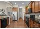 Bright kitchen with stainless steel refrigerator, dark cabinetry and hardwood flooring at 113 Artisan Ct, Mooresville, NC 28117
