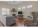 Open living room with hardwood floors, a fireplace, and large windows for ample lighting at 113 Artisan Ct, Mooresville, NC 28117
