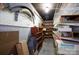 Unfinished basement area with exposed ceiling, cinder block walls, and storage shelves, providing utility space at 118 Sunset Dr, Chester, SC 29706