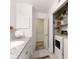 Bright bathroom features granite countertops, white cabinetry, and tile flooring near a laundry area at 118 Sunset Dr, Chester, SC 29706
