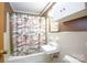 A charming bathroom with a tub and shower combination, a white sink and toilet, and light-colored tile at 118 Sunset Dr, Chester, SC 29706