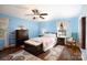This blue bedroom features a wooden ceiling fan, matching furniture, and hardwood floors at 118 Sunset Dr, Chester, SC 29706