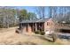 Charming two-story brick home features a covered porch, attached garage, and mature trees at 118 Sunset Dr, Chester, SC 29706