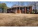 Elegant brick home with classic colonial design, featuring a grand entrance and manicured front lawn at 118 Sunset Dr, Chester, SC 29706