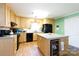 Bright kitchen features wooden cabinets, a central island with wine fridge, and modern black appliances at 118 Sunset Dr, Chester, SC 29706