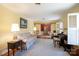 Comfortable living room with a floral sofa, piano, and seamless flow into the dining area at 118 Sunset Dr, Chester, SC 29706