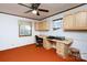 A home office featuring wooden cabinetry, desk, ceiling fan and window for natural light, adding warmth and utility to the space at 118 Sunset Dr, Chester, SC 29706