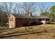 Rear view of a brick home showcasing its well-kept lawn and architectural details at 118 Sunset Dr, Chester, SC 29706