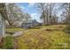 View of the home's expansive backyard with lush greenery and mature trees providing privacy at 11924 Parks Farm Ln, Charlotte, NC 28277