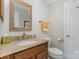 Cozy powder room featuring an oval sink, granite counters, and decorative framed mirror at 11924 Parks Farm Ln, Charlotte, NC 28277
