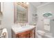Well-lit bathroom featuring a vanity with a quartz countertop and framed mirror at 11924 Parks Farm Ln, Charlotte, NC 28277