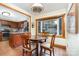 Bright breakfast nook featuring a bay window, wood trim, and kitchen view for casual dining at 11924 Parks Farm Ln, Charlotte, NC 28277
