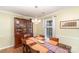 Well-lit dining area featuring a classic china cabinet, window view, and comfortable seating for Gathering meals at 11924 Parks Farm Ln, Charlotte, NC 28277