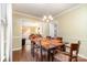 Inviting dining room featuring hardwood floors, elegant lighting, and seamless flow to the living space at 11924 Parks Farm Ln, Charlotte, NC 28277