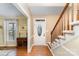 Warm foyer featuring hardwood floors, a staircase, and a decorative front door at 11924 Parks Farm Ln, Charlotte, NC 28277