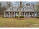 Inviting two-story home with a covered front porch, classic shutters, and well-maintained lawn at 11924 Parks Farm Ln, Charlotte, NC 28277