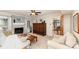 Bright living room with a fireplace, hardwood furniture, and a view to the dining area at 11924 Parks Farm Ln, Charlotte, NC 28277