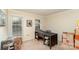 Office area with a dark desk, carpeted floor and natural light streaming through the windows at 11924 Parks Farm Ln, Charlotte, NC 28277