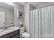 Bright bathroom featuring granite countertop vanity and tub-shower with decorative curtain at 1210 Croft Dr # 96, Fort Mill, SC 29708