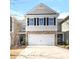 Charming two-story home with stone accents and a spacious two-car garage and a well-kept lawn at 1210 Croft Dr # 96, Fort Mill, SC 29708