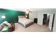 This bedroom features a neutral carpet, a ceiling fan, and a large bed facing an open doorway at 1210 Croft Dr # 96, Fort Mill, SC 29708