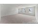 Spacious bonus room features neutral carpet and natural light from three windows at 122 Tillery Ln # 759P, Mount Gilead, NC 27306