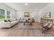 Cozy living room with neutral decor, large windows, and wood-style flooring for a bright and inviting atmosphere at 122 Tillery Ln # 759P, Mount Gilead, NC 27306