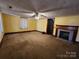 Open living area with a decorative fireplace, neutral carpet, and great natural light at 1222 Sparrow Springs Rd, Kings Mountain, NC 28086