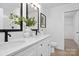Elegant bathroom featuring double sinks, white cabinets, and decorative accents at 13110 Blacksmith Ct, Matthews, NC 28105