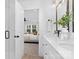 Stylish bathroom with a double sink vanity, and an open view into the bedroom at 13110 Blacksmith Ct, Matthews, NC 28105