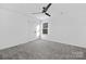 Clean bedroom featuring a ceiling fan, double door closet, and a window at 13110 Blacksmith Ct, Matthews, NC 28105