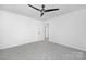 Minimalist bedroom with a modern ceiling fan and neutral carpeting at 13110 Blacksmith Ct, Matthews, NC 28105
