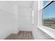 Bright walk-in closet with built-in shelving and a window at 13110 Blacksmith Ct, Matthews, NC 28105