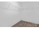 Spacious walk-in closet featuring ample shelving for storage at 13110 Blacksmith Ct, Matthews, NC 28105